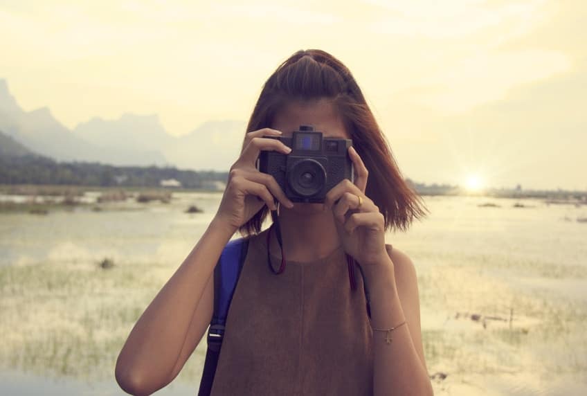 Young woman taking photograph