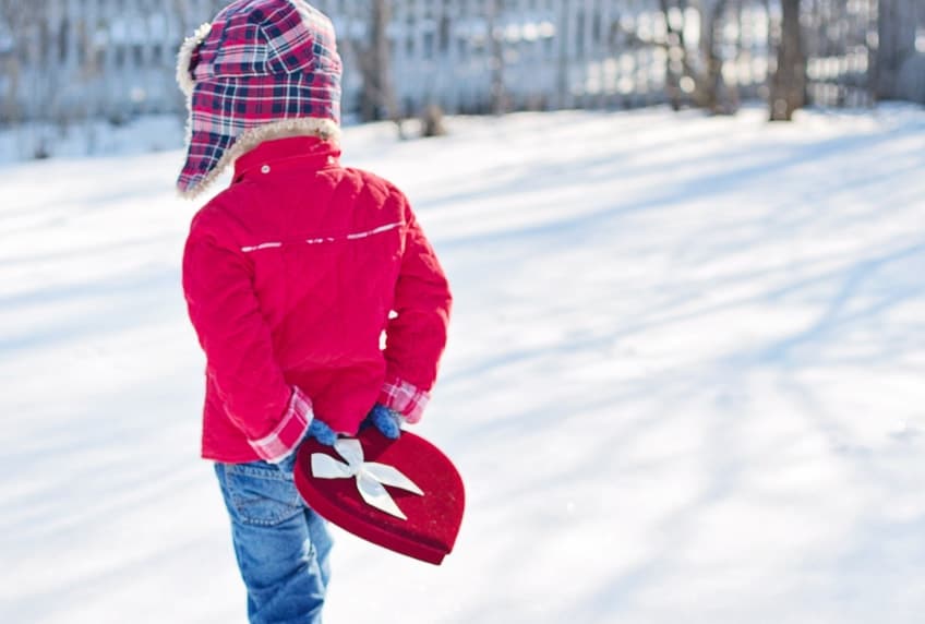 Little boy carrying heart shaped gift